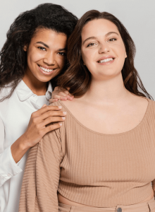 Two young woman smiling