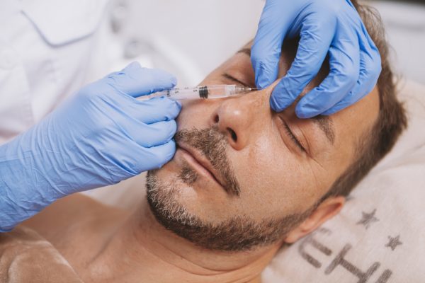man receiving dermal fillers for the nose