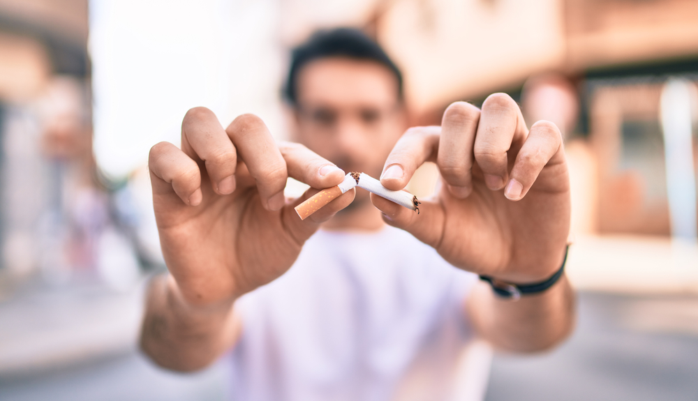 man breaking cigarette